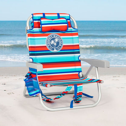 Colorful striped beach chair with a Tommy Bahama logo on a sandy beach.